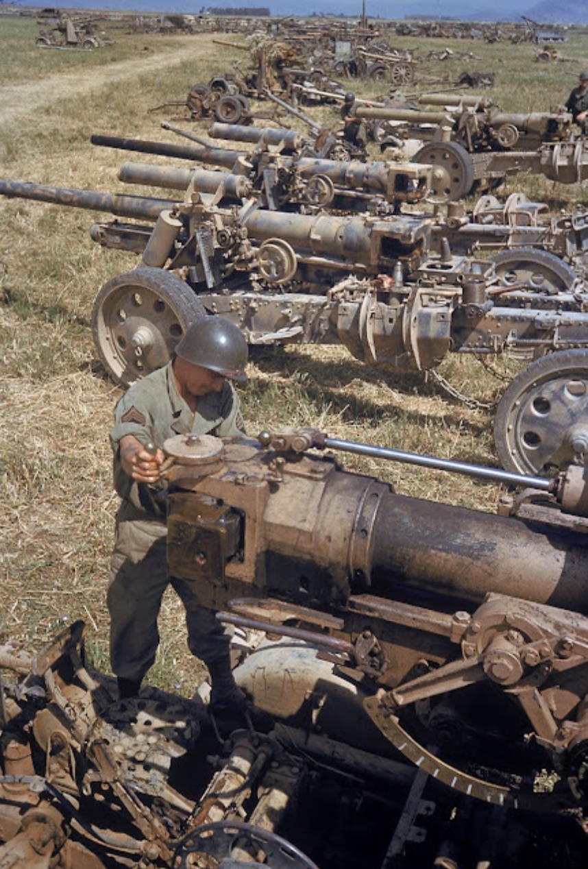 An American G.I. inspects German artillery captured or destroyed in the battle of El Guettar 
